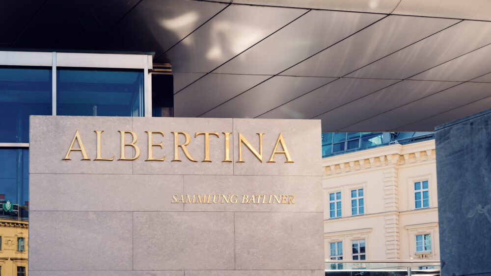 Golden Albertina sign on the exterior of the museum's modern wing.